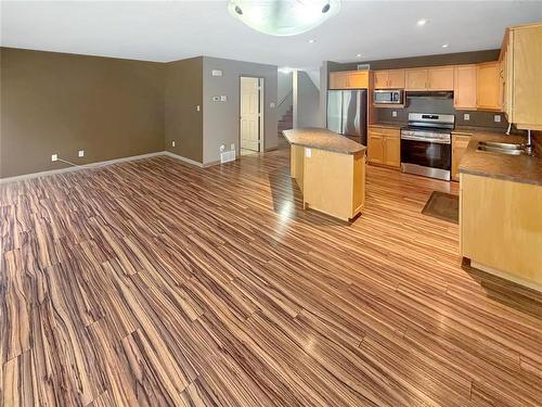 64 Coulter Way, Brandon, MB - Indoor Photo Showing Kitchen With Double Sink