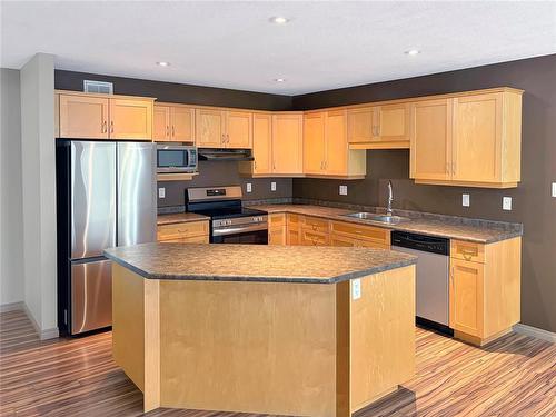 64 Coulter Way, Brandon, MB - Indoor Photo Showing Kitchen With Double Sink