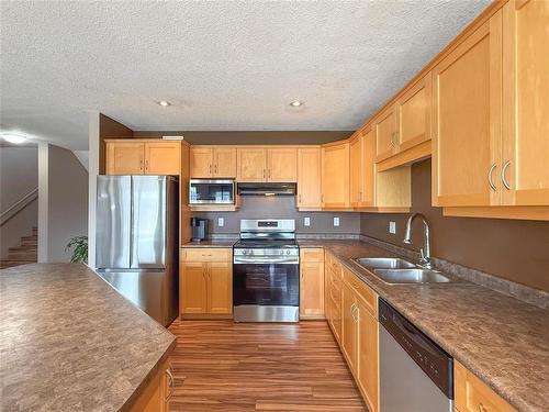 64 Coulter Way, Brandon, MB - Indoor Photo Showing Kitchen With Double Sink