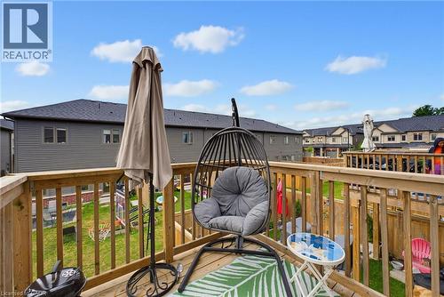 Expansive outdoor wood deck with natural wood railings, overlooking a fenced backyard with green space - 324 Equestrian Way Unit# 49, Cambridge, ON - Outdoor With Deck Patio Veranda With Exterior