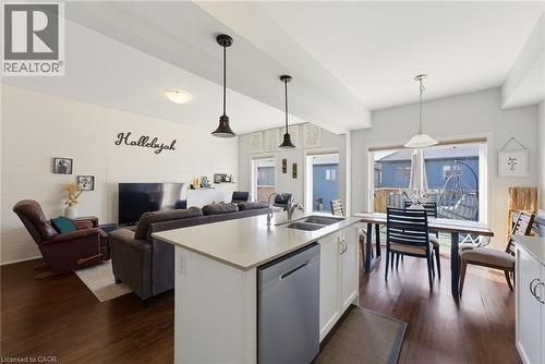 Open-concept living space featuring wood-finish flooring, white walls, and recessed lighting - 324 Equestrian Way Unit# 49, Cambridge, ON - Indoor Photo Showing Other Room