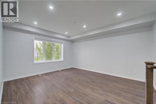 Spacious interior with wood-finish flooring, recessed lighting, and a large multi-pane window - 911 Apple Hill Lane, Kitchener, ON - Indoor Photo Showing Other Room