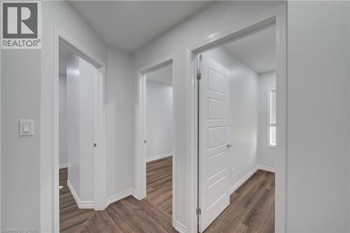 Hallway featuring wood-finish flooring, white trim, and light gray walls - 911 Apple Hill Lane, Kitchener, ON - Indoor Photo Showing Other Room