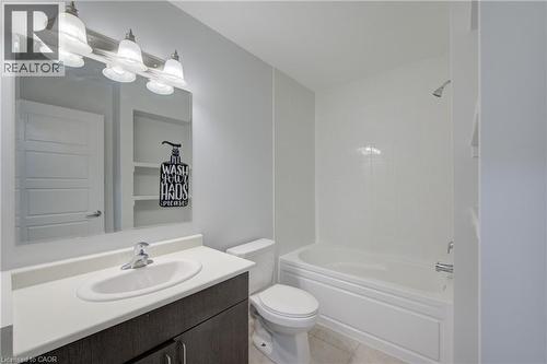 Contemporary bathroom featuring a dark wood-finish vanity with a white countertop and undermount sink - 911 Apple Hill Lane, Kitchener, ON - Indoor Photo Showing Bathroom