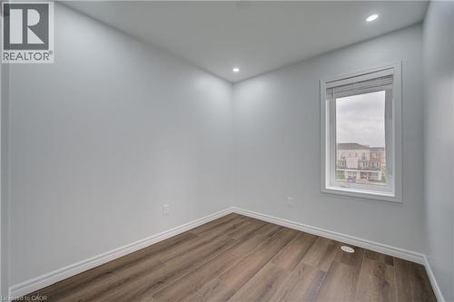 Room featuring wood-finish flooring, white baseboards, and neutral wall paint - 911 Apple Hill Lane, Kitchener, ON - Indoor Photo Showing Other Room