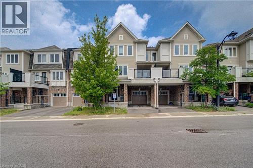 Multi-story townhome featuring light-toned siding and brick accents - 911 Apple Hill Lane, Kitchener, ON - Outdoor With Balcony With Facade