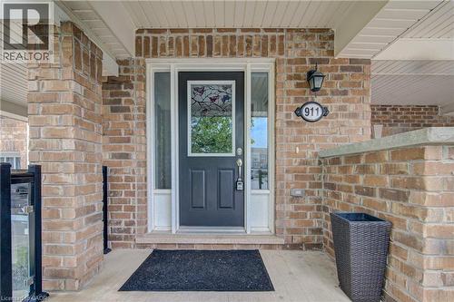 Brick exterior featuring a paneled entry door with decorative glass inserts and clear side lites - 911 Apple Hill Lane, Kitchener, ON -  With Exterior
