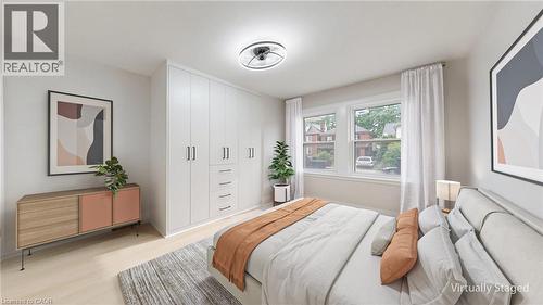 Integrated white cabinetry with matte black pulls and drawer storage - 59 Longwood Road N, Hamilton, ON - Indoor Photo Showing Bedroom
