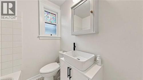 Bathroom featuring a white rectangular vessel sink, matte black faucet, and a wall-mounted medicine cabinet with a mirror - 59 Longwood Road N, Hamilton, ON - Indoor Photo Showing Bathroom