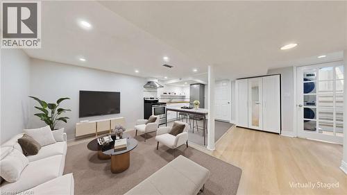 Open-concept living area with light wood-finish flooring and recessed lighting - 59 Longwood Road N, Hamilton, ON - Indoor