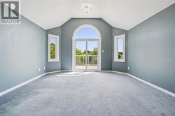 Room featuring a vaulted ceiling and light blue walls - 