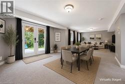Spacious finished lower level featuring light gray walls and plush carpeting throughout - 