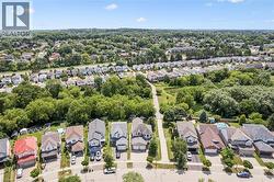 Aerial perspective showcasing a residential street with diverse architectural styles, individual garages, and private driveways - 