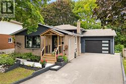 Brick and dark siding exterior with a welcoming covered front porch and wooden steps - 