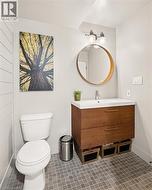 Contemporary bathroom featuring a floating wood-finish vanity with a white countertop and integrated sink - 