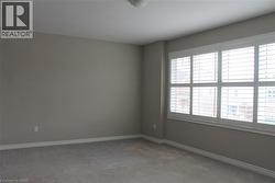 Generous window with white plantation shutters - 