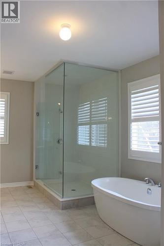 Freestanding bathtub and frameless glass shower enclosure - 31 Pointer Street Unit# Main Floor, Cambridge, ON - Indoor Photo Showing Bathroom