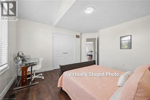 Bedroom with wood-finish flooring, white painted walls, and a window with blinds - 145 Redtail Street, Kitchener, ON - Indoor Photo Showing Bedroom