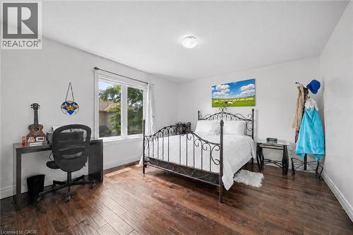 Bright room featuring wood-finish flooring and a large window - 145 Redtail Street, Kitchener, ON - Indoor Photo Showing Bedroom