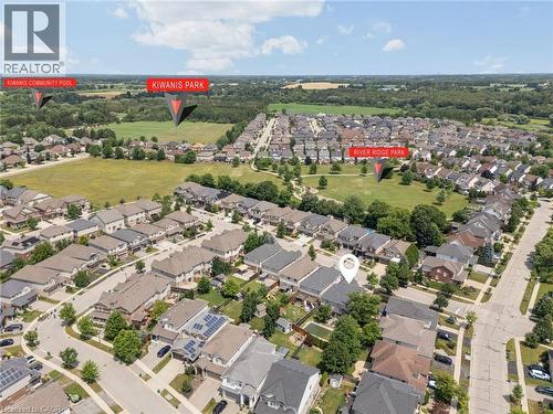 Aerial view showcasing a residential neighborhood with detached homes, green spaces, and a tree-lined perimeter - 145 Redtail Street, Kitchener, ON - Outdoor With View
