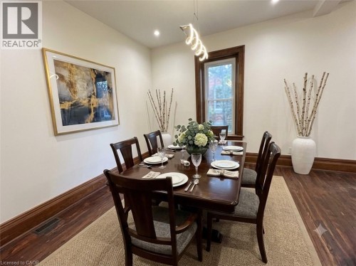 Dining area featuring wood-finish flooring, white walls, and dark wood trim - 245 Lowther Street S, Cambridge, ON - Indoor Photo Showing Dining Room