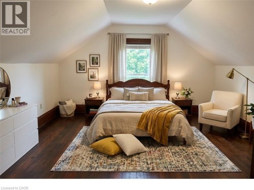 Bedroom featuring wood-finish flooring, sloped ceilings, and a window with natural light - 245 Lowther Street S, Cambridge, ON - Indoor Photo Showing Bedroom