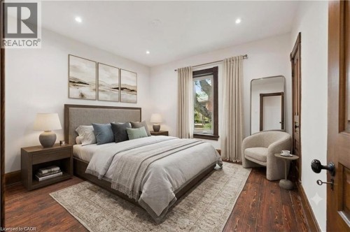 Bright room featuring dark wood-finish flooring, recessed ceiling lighting, and a window with neutral drapes - 245 Lowther Street S, Cambridge, ON - Indoor Photo Showing Bedroom