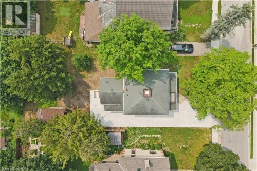 Aerial perspective showcasing the property's roofline, surrounding mature trees, and paved driveway - 245 Lowther Street S, Cambridge, ON - Outdoor