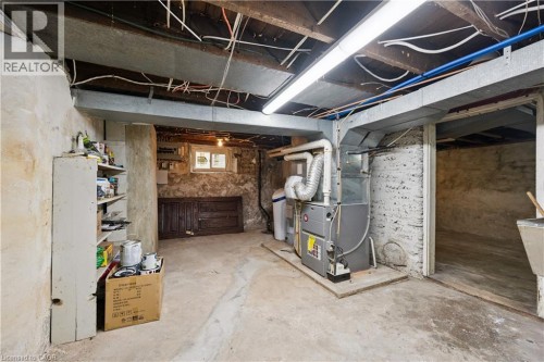 Basement utility space featuring a furnace, water heater, water softener, and exposed ceiling beams - 245 Lowther Street S, Cambridge, ON - Indoor Photo Showing Basement