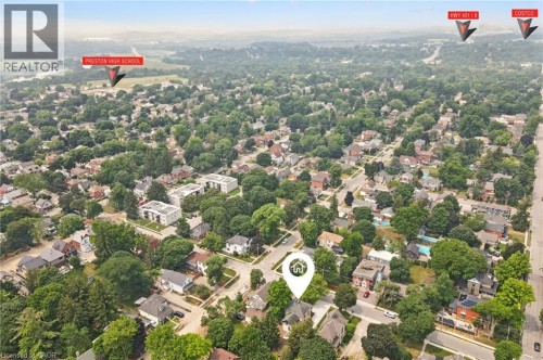 Aerial perspective showcasing a residential area with a mix of single-family homes and multi-story buildings, surrounded by mature trees - 245 Lowther Street S, Cambridge, ON - Outdoor With View