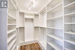 Walk in closet with custom built in shelving - 