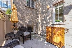 Exterior stone facade featuring a ground-level patio with concrete surfacing - 