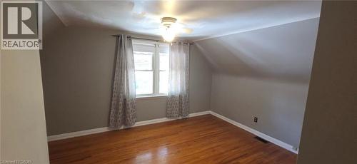 Room with wood-finish flooring, a window with curtains, and a ceiling fan with integrated lighting - 274 East 38Th Street, Hamilton, ON - Indoor Photo Showing Other Room