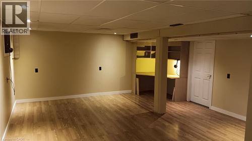Spacious room featuring wood-finish flooring, recessed lighting, built-in shelving, and a built-in desk area - 274 East 38Th Street, Hamilton, ON - Indoor Photo Showing Other Room