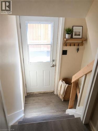 Entryway featuring a paneled door with an upper window, wood-finish flooring, and a light-toned wall color - 274 East 38Th Street, Hamilton, ON - Indoor Photo Showing Other Room