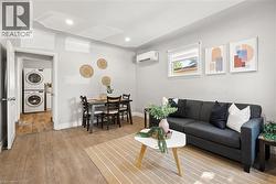 Open-concept living area featuring wood-finish flooring, recessed lighting, and a ductless mini-split system - 