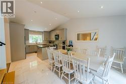 Open-concept kitchen and dining area featuring a vaulted ceiling with recessed lighting - 