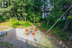 Outdoor fire pit area with gravel hardscaping and natural stone accents - 