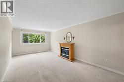 Spacious room featuring neutral wall paint and plush carpet flooring - 