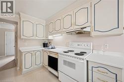 Kitchen featuring white cabinetry with blue trim, a white electric range, and a built-in dishwasher - 