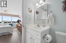 White vanity with an integrated sink, polished chrome faucet, and a wall-mounted medicine cabinet - 