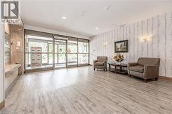 Lobby entrance featuring full-height glass doors and wood-finish flooring - 