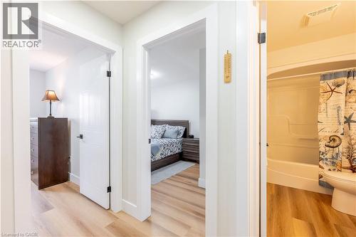 Neutral tone wood-finish flooring extends throughout the hallway - 185 Highland Crescent Unit# 2, Kitchener, ON - Indoor
