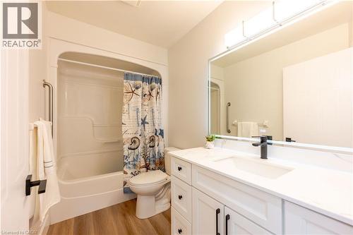 Bathroom featuring a white vanity with an integrated sink, quartz-finish countertop, matte black faucet, and wood-finish flooring - 185 Highland Crescent Unit# 2, Kitchener, ON - Indoor Photo Showing Bathroom