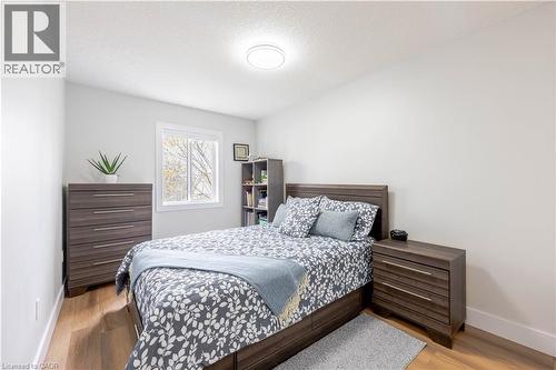 Bedroom featuring wood-finish flooring, white walls, and a window with white trim - 185 Highland Crescent Unit# 2, Kitchener, ON - Indoor Photo Showing Bedroom