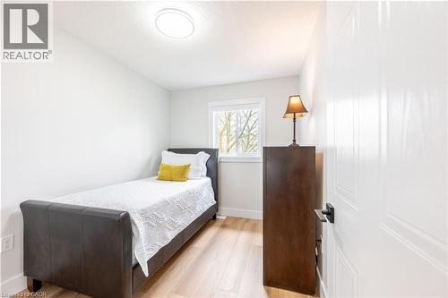 Bright room featuring light wood-finish flooring, white walls, and a single window with white trim - 185 Highland Crescent Unit# 2, Kitchener, ON - Indoor Photo Showing Bedroom