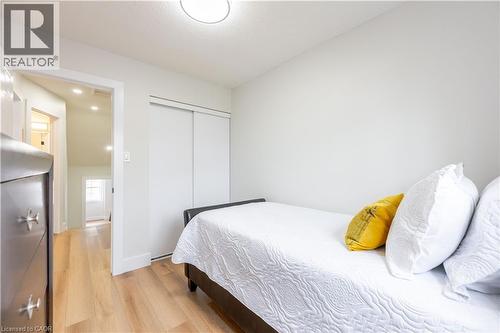 Compact room featuring light wood-finish flooring, white walls, and a ceiling-mounted flush light fixture - 185 Highland Crescent Unit# 2, Kitchener, ON - Indoor Photo Showing Bedroom
