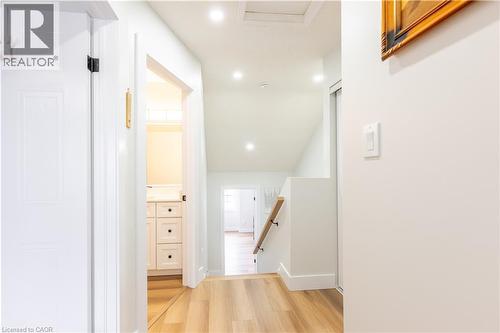Bright hallway featuring wood-finish flooring, recessed lighting, and a white interior door with black hardware - 185 Highland Crescent Unit# 2, Kitchener, ON - Indoor Photo Showing Other Room