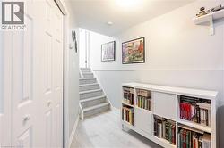 Light-toned wood-finish flooring extending from the entryway - 