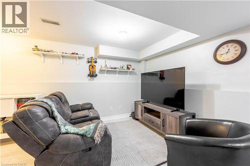 Recreation space featuring overhead lighting, light-toned walls with a chair rail, and soft-tone carpeting - 185 Highland Crescent Unit# 2, Kitchener, ON - Indoor